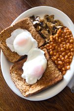2 poached eggs on 2 toast wit mushrooms and beans
